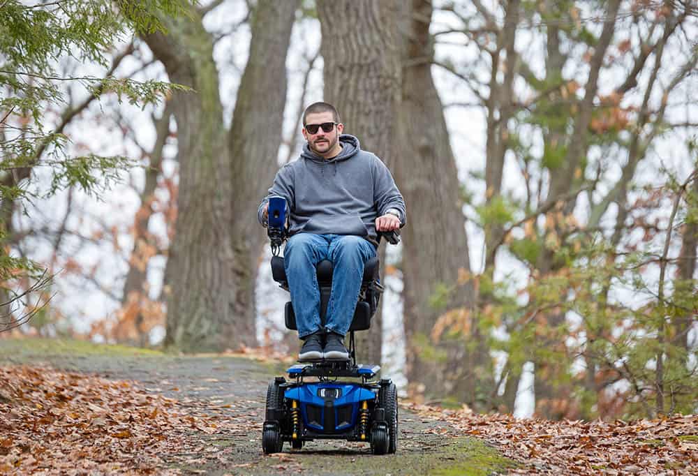 Quantum Edge 3 powerchair being ridden in the woods
