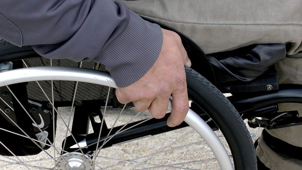 Wheelchair with man hand forPersonal Health Budgets