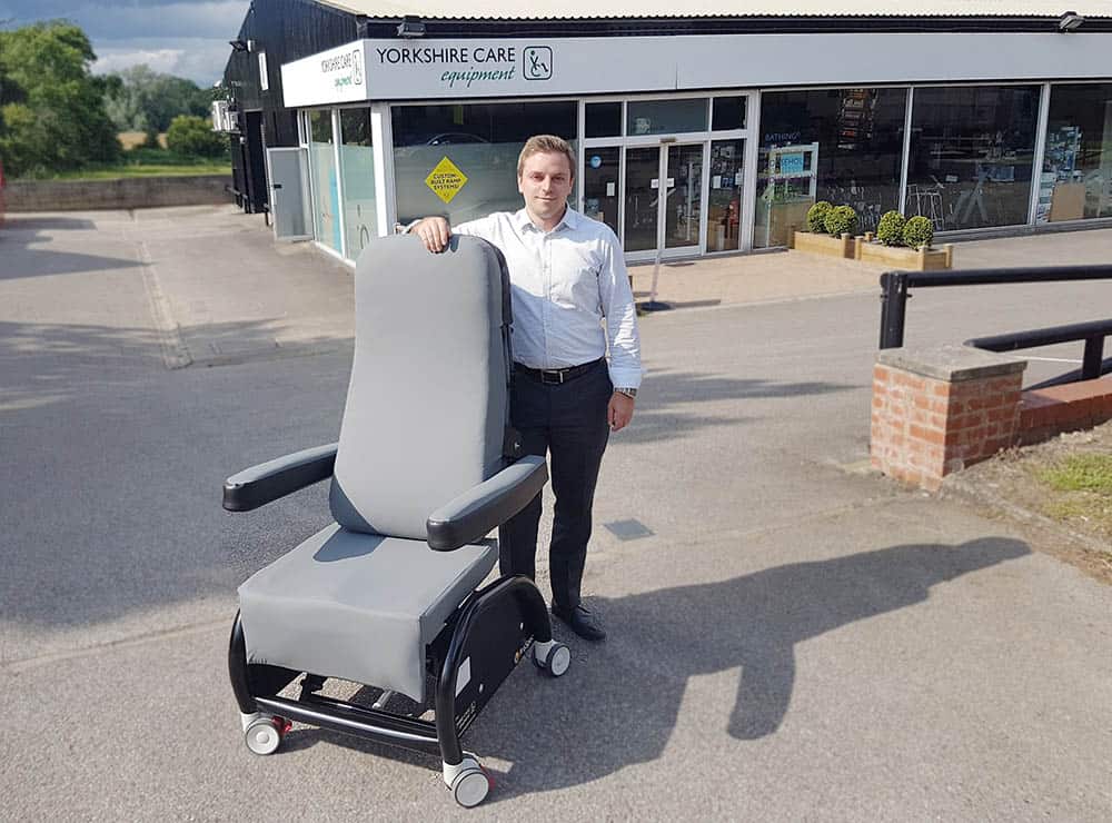 Yorkshire Care's MD Tristan Hulbert with the ProSpec Hospital Chair