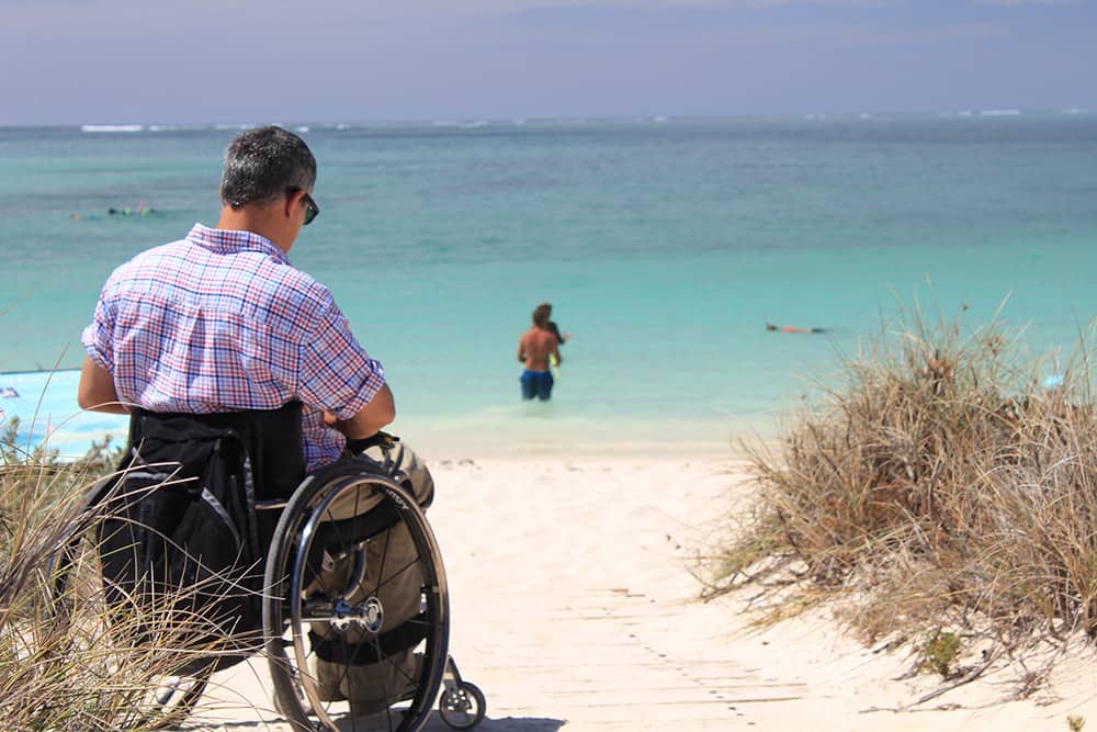 Wheelchair user at a sandy beach image