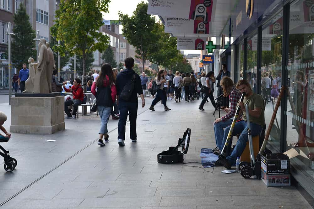 UK High Street with buskers playing music