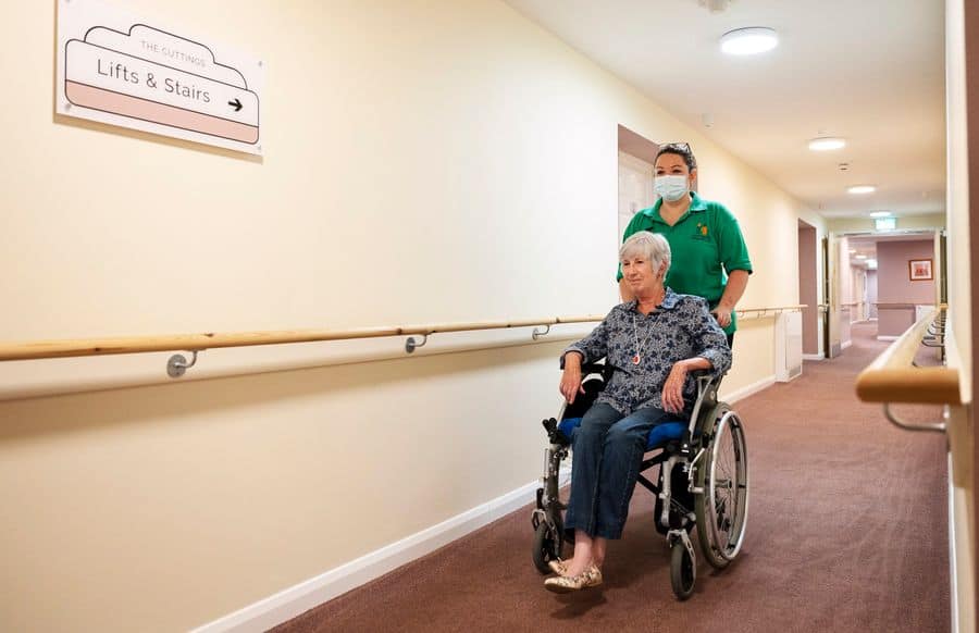 Wheelchair user and carer credit Tunstall Healthcare
