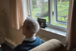 Image by Centre for Ageing Better: Elderly gentleman sat by a window looking into his garden