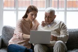 Woman and older man on laptop