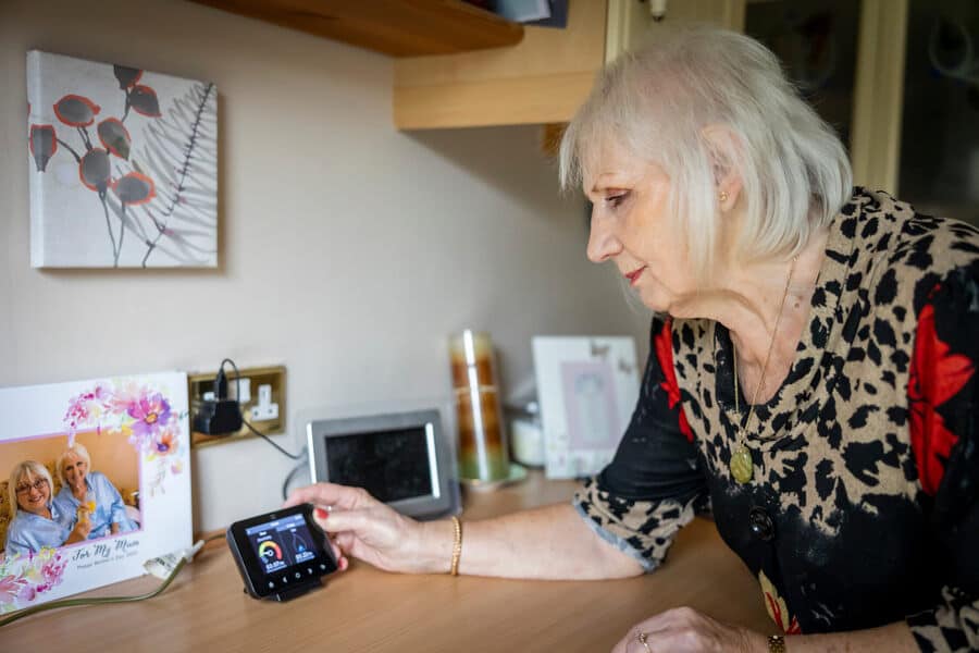 Elderly woman adjusts smart meter